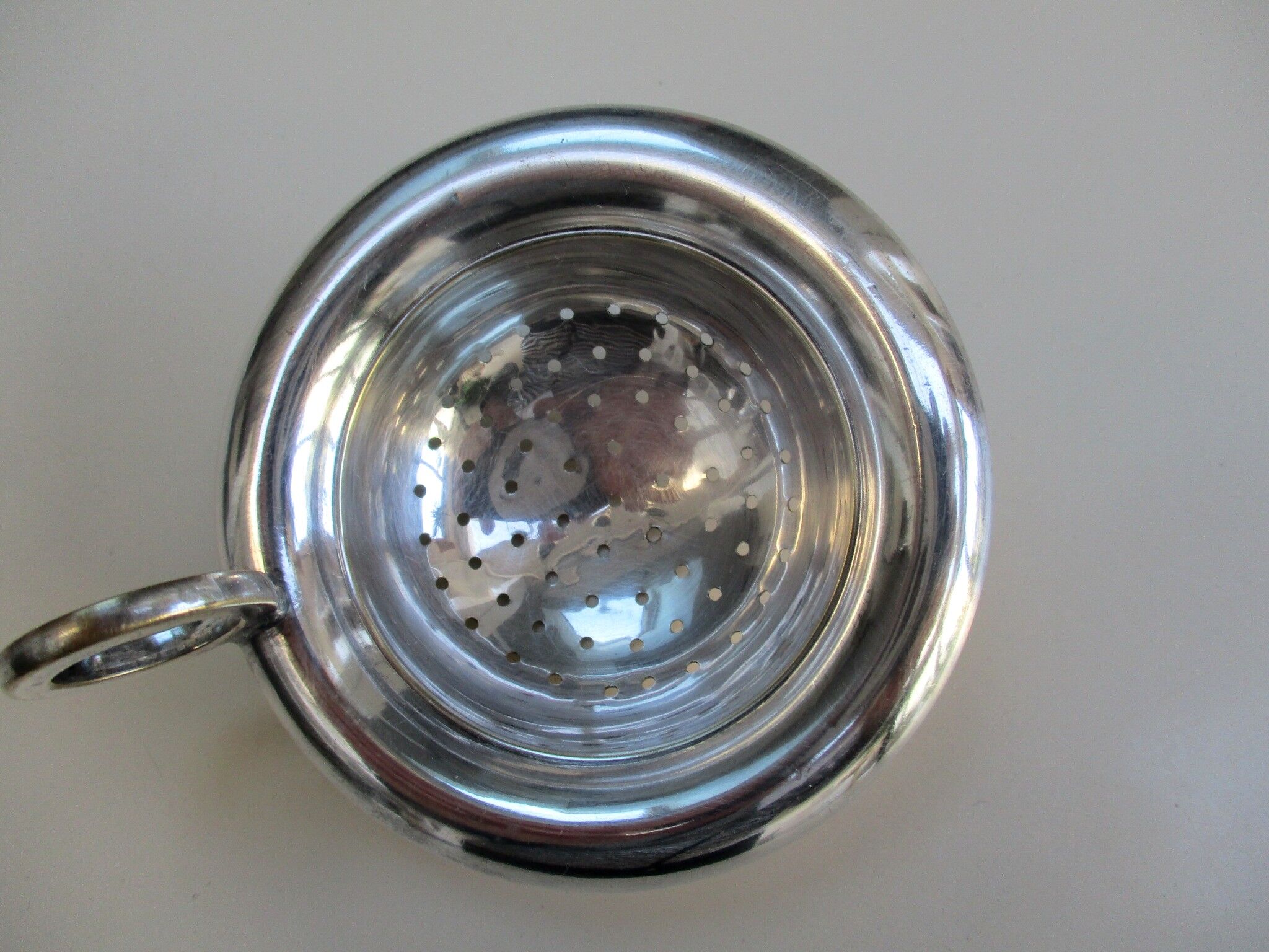 Silver metal tea strainer