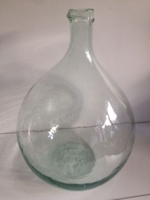 Transparent old demijohn about 8 to 10 L