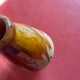 Large antique pottery bottle in glazed terracotta with drips.
