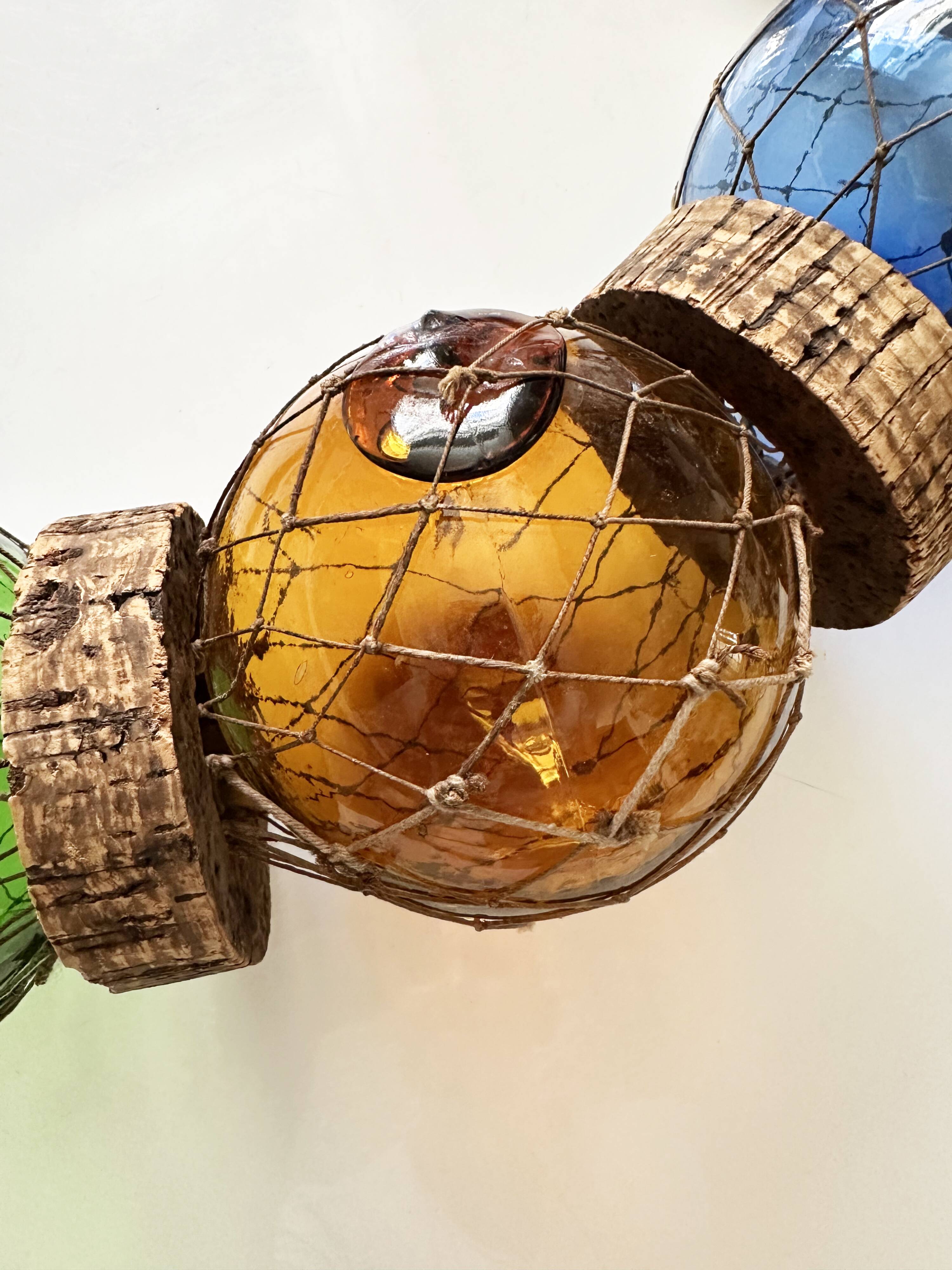 Fishing floats made of blown glass, cork, and rope. France, 1960s.