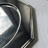 Many octagonal presentation plates in silver-plated metal.