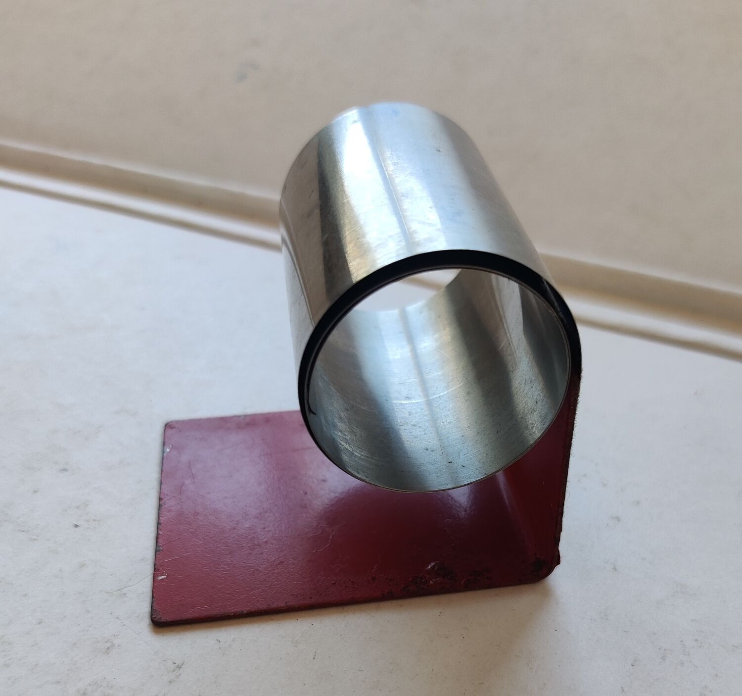 Modernist extendable bookends in brushed stainless steel and red 1970's