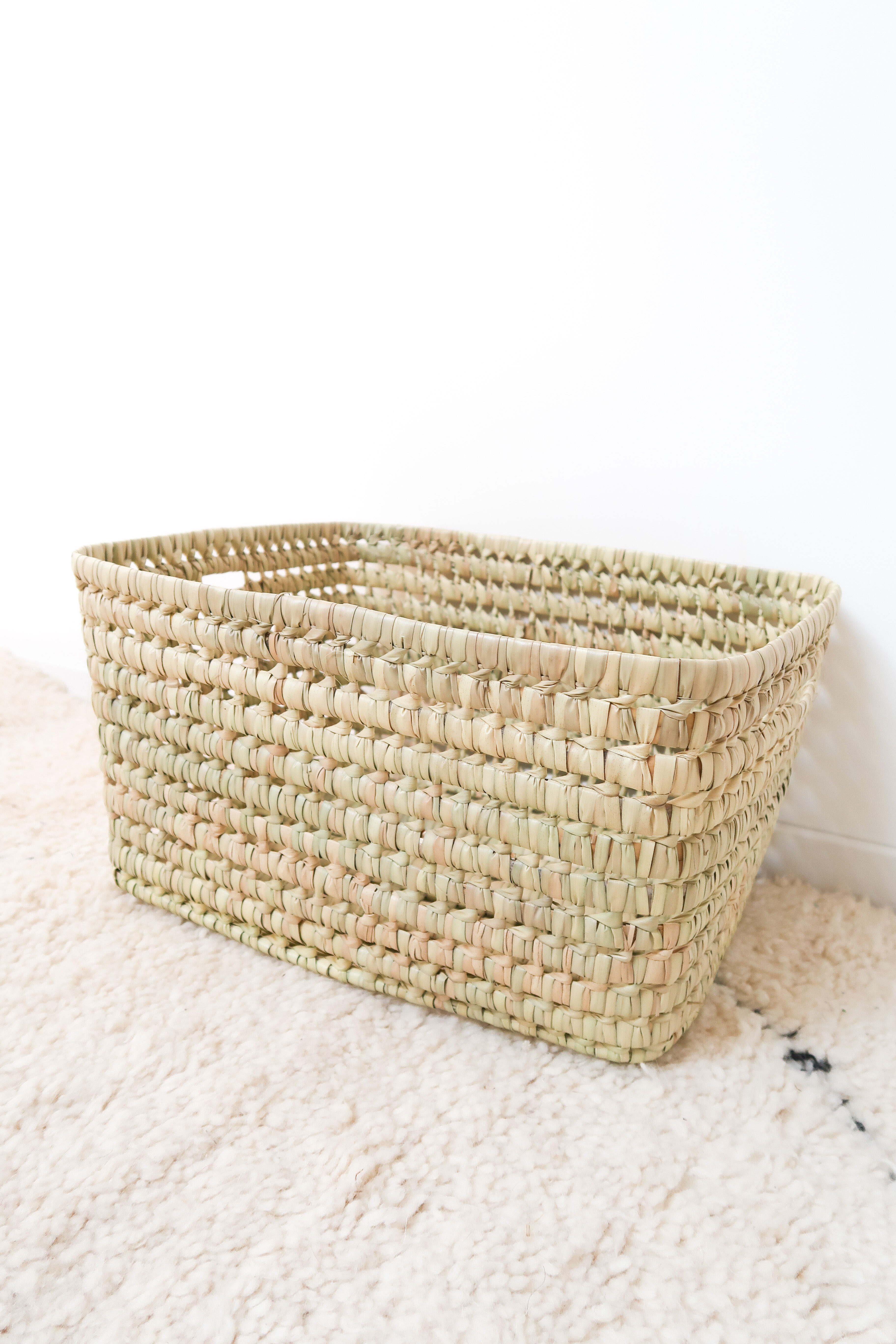 Storage basket in braided palm leaves