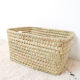 Storage basket in braided palm leaves