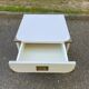 White Scandinavian bedside table in boat style made of wood.