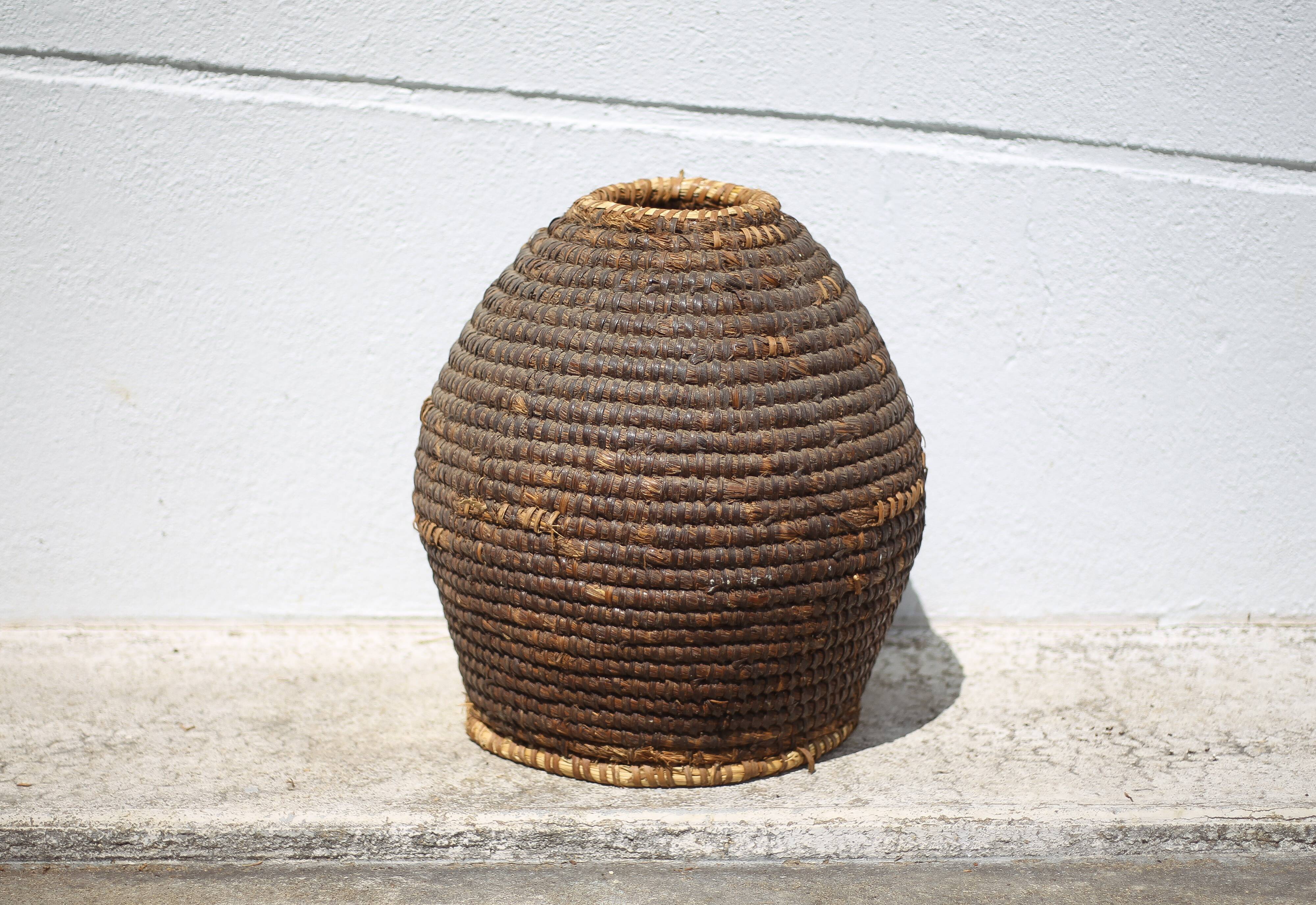 Old basket, burgundy straw and bramble, woven basket, interior decoration, pantry, flowerpot