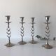 Four twisted silver candlesticks