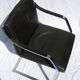 Chair with steel and leather armrests