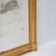 19th-century patinated mirror with a ribbon-style frame