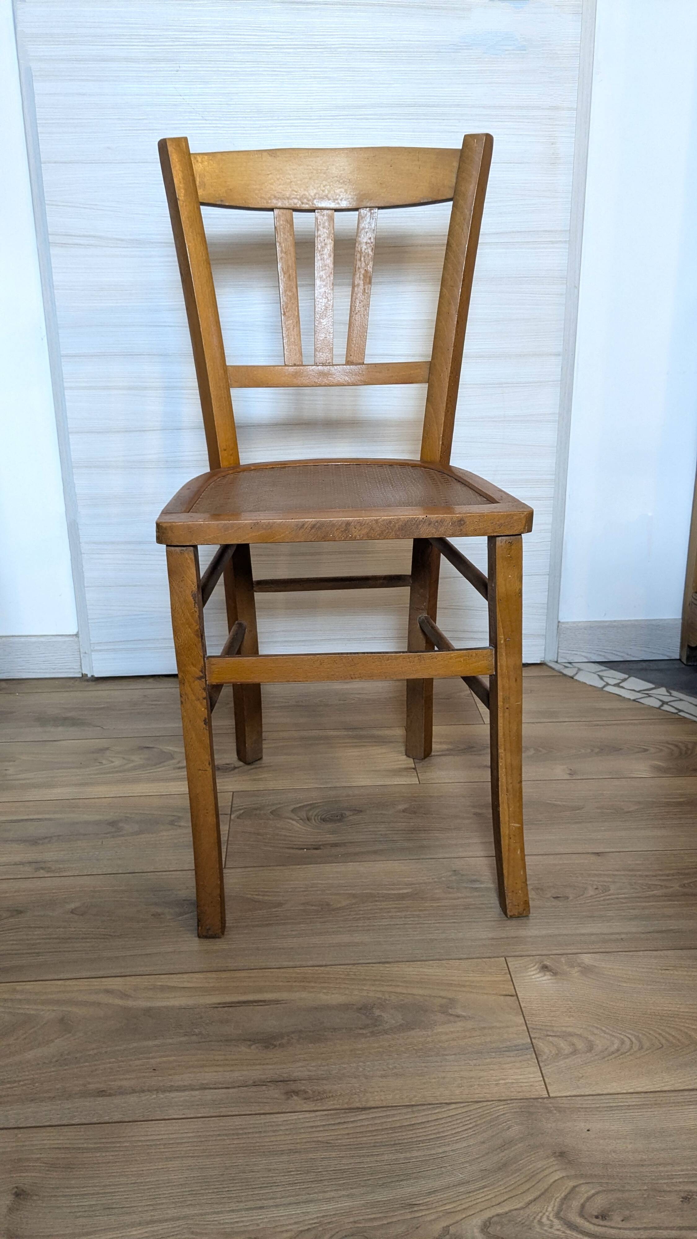 Antique patinated wooden bistro chair from the early 20th century.
