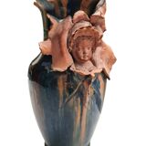 Terracotta vase with a child's head