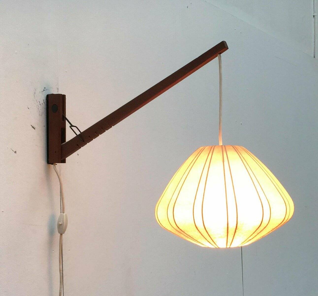 Mid-century pivoting wall lamp with a swing arm, Cocoon, made of teak wood, 1960s.
