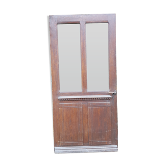 Old-glassed entrance door in tangled oak