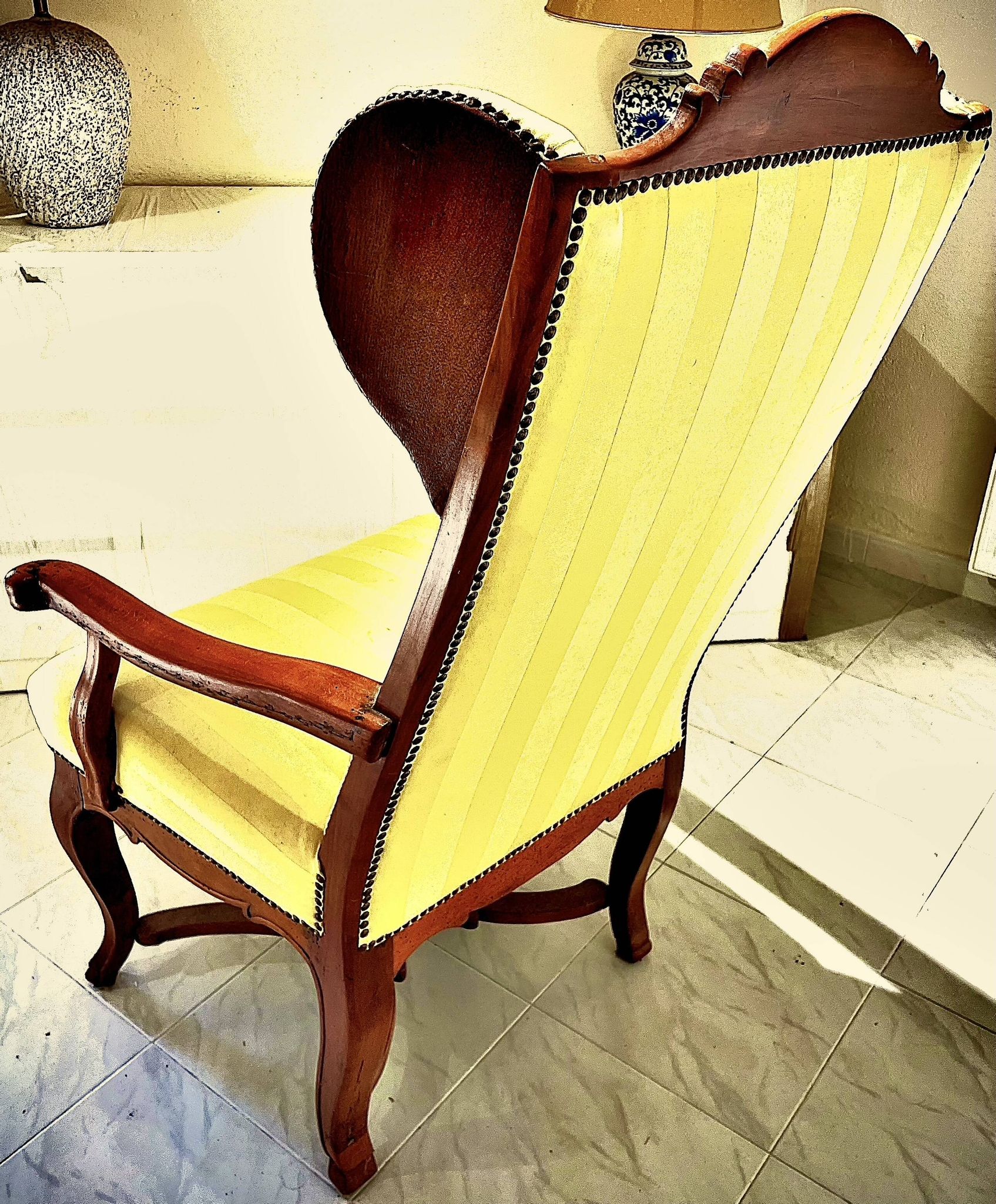 Wingback armchair in walnut in the French Regency style with stretcher in