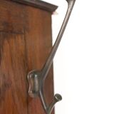 Antique brown wooden coat rack with mirror and umbrella stand, 1900 style.