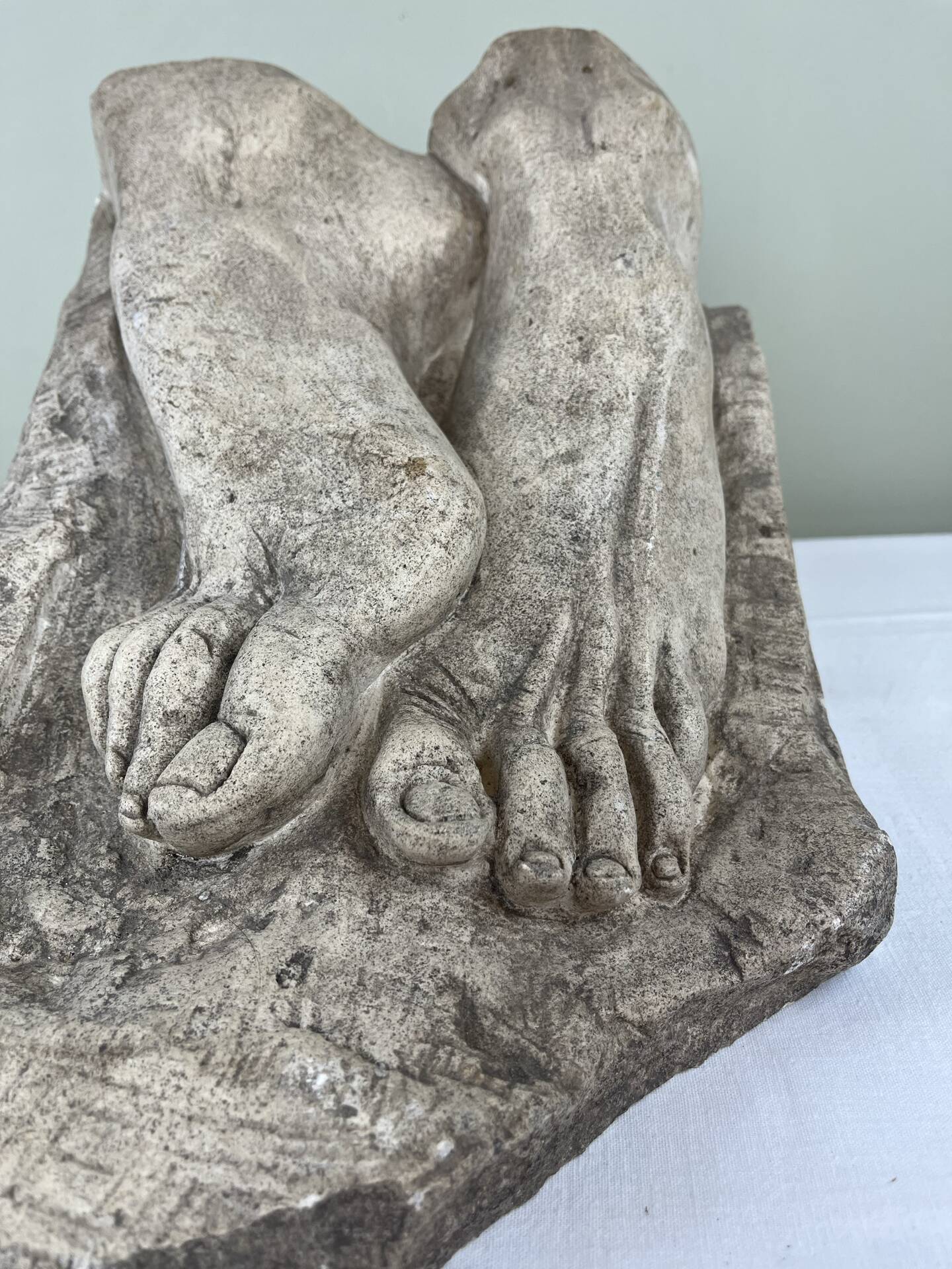 Stone sculpture, two feet on a block, signed D. Paillot.