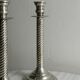 Patinated silver-plated metal candlesticks