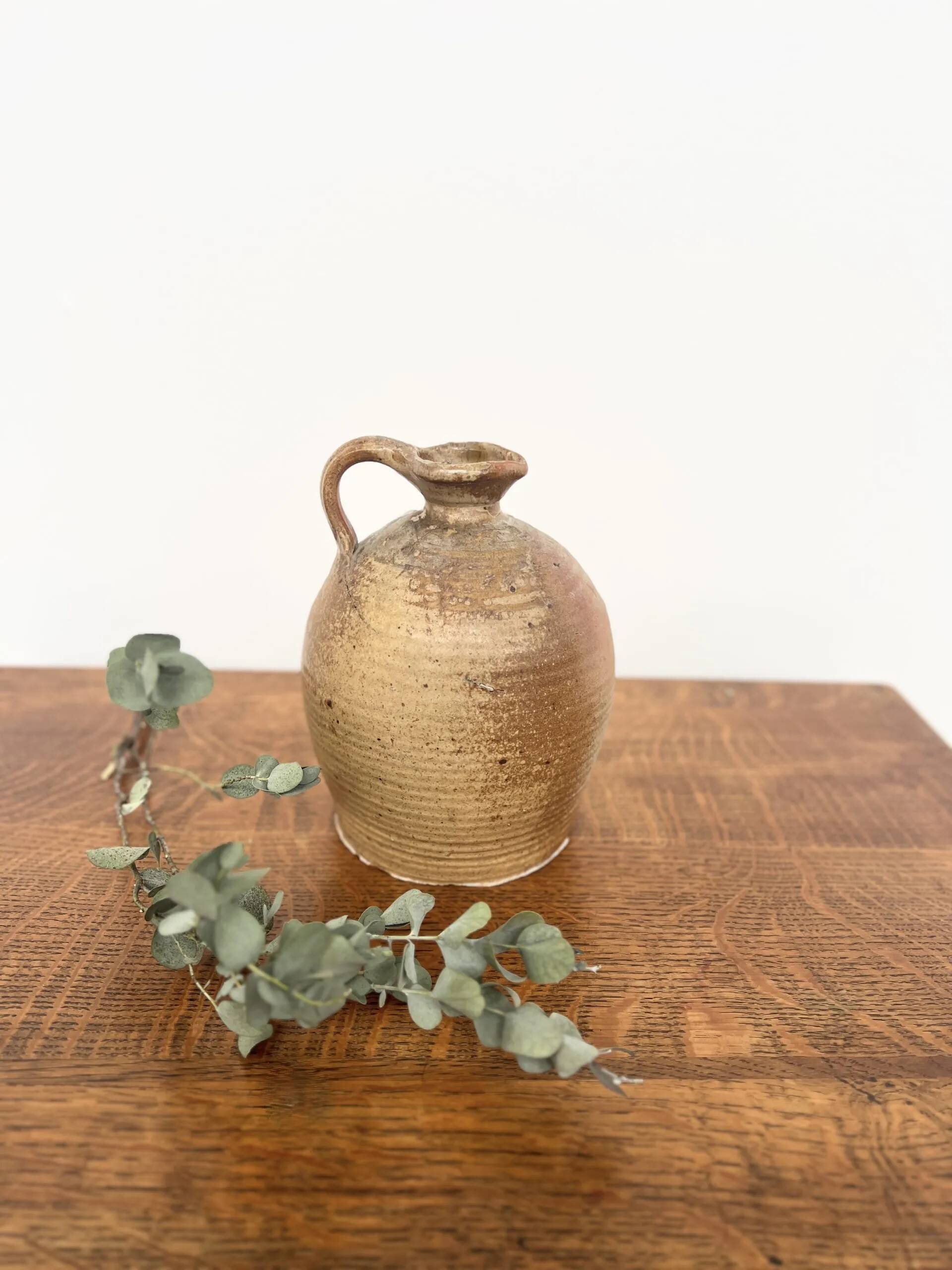 Small antique stoneware jar with handle