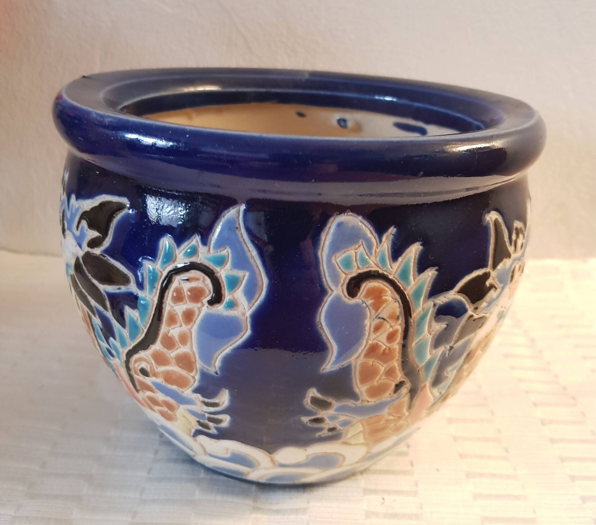 Decorative pot in multicoloured relief glazed ceramic.