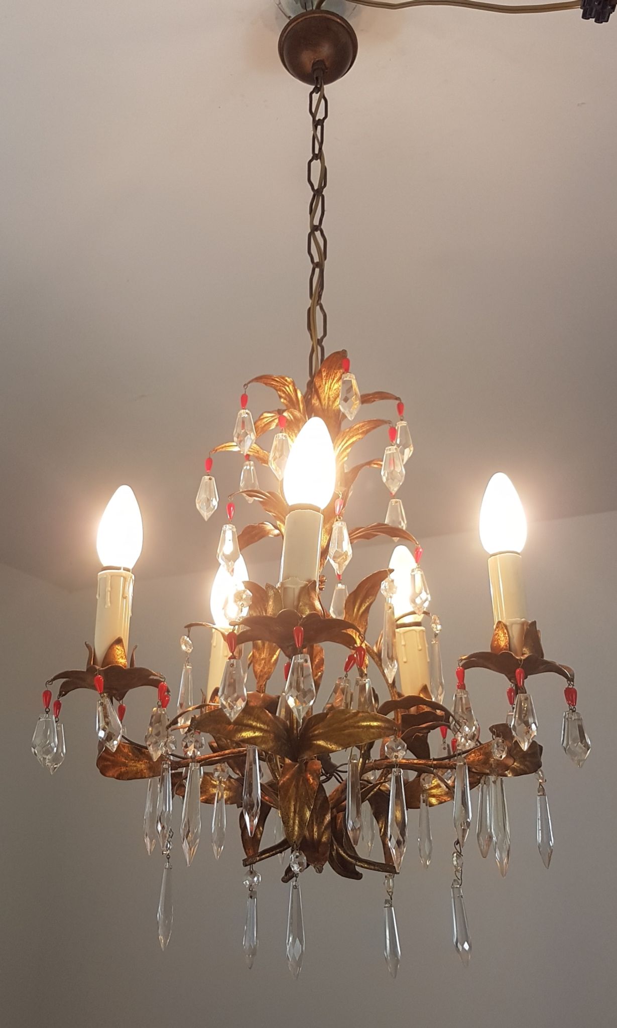 Gold metal chandelier and stamps