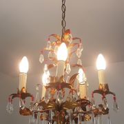 Gold metal chandelier and stamps