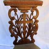 Low armchair in carved wood