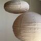 Average suspension in natural rattan and linen, Japanese-style, flattened oval in pink.