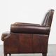 Dark brown sheepskin armchair finished with decorative nails
