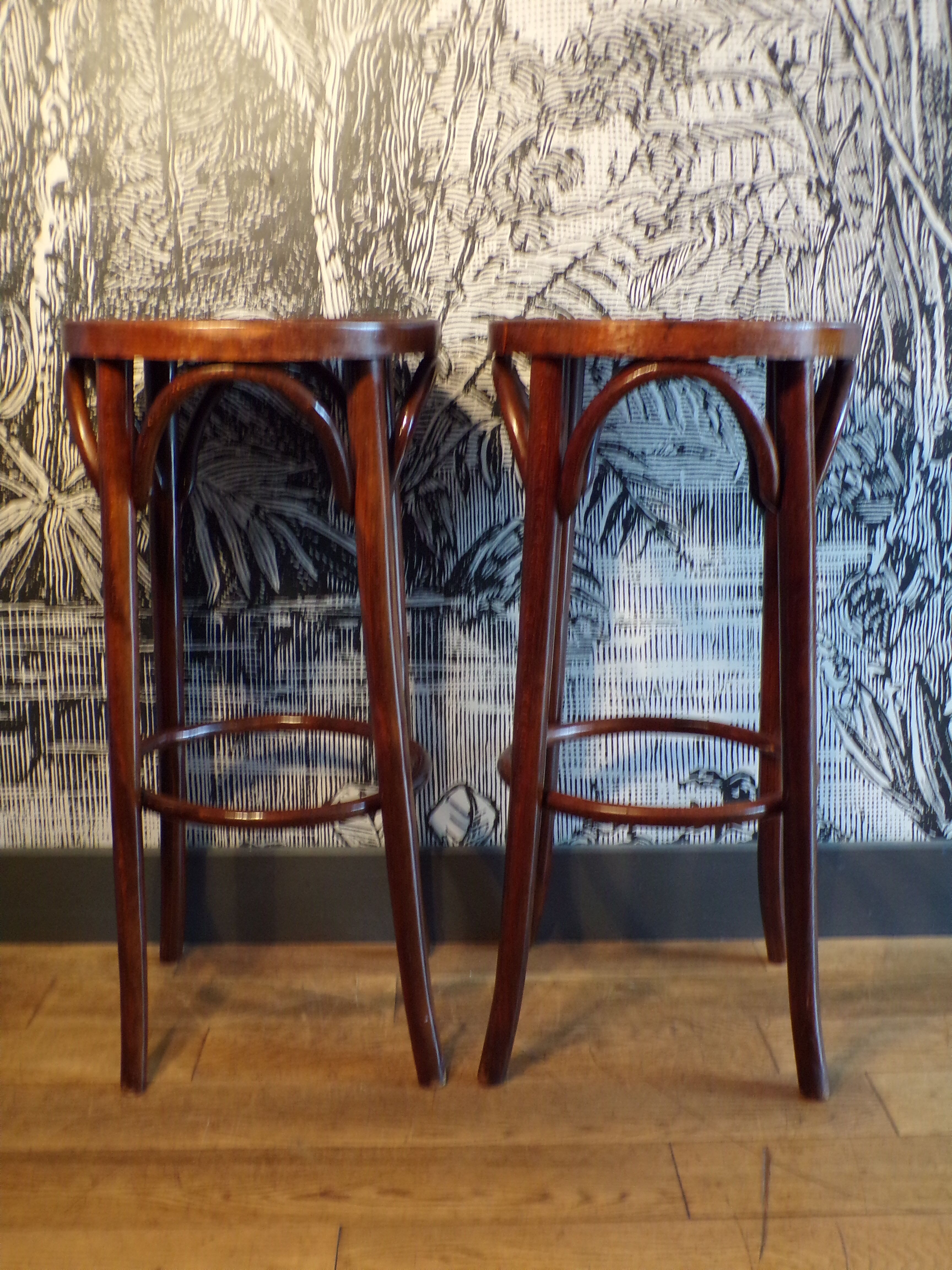 2 curved wooden bar stools