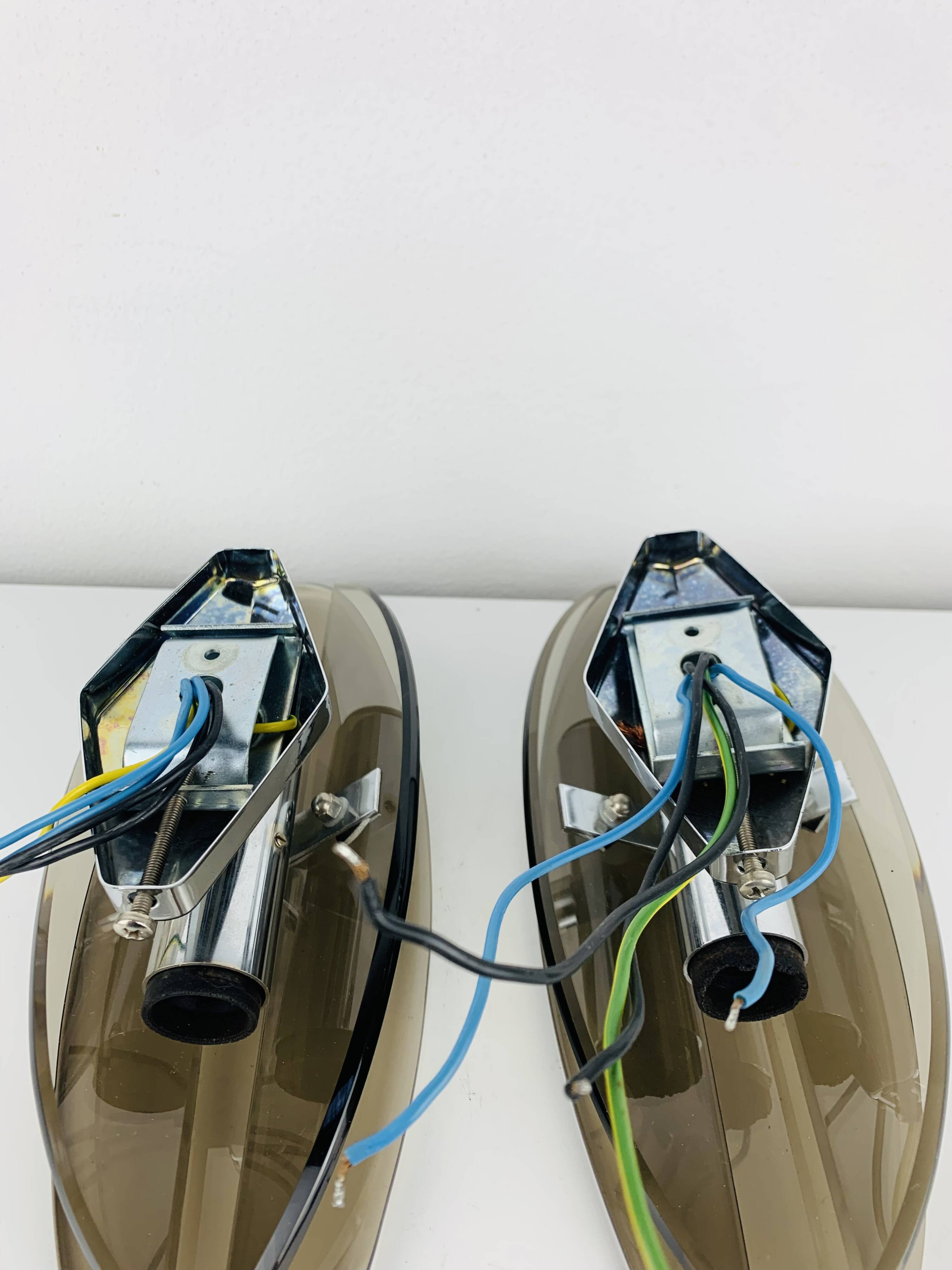 Pair of smoked glass and chrome wall lights from the 1970s.