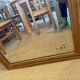 Grand miroir ancien en bois patiné doré