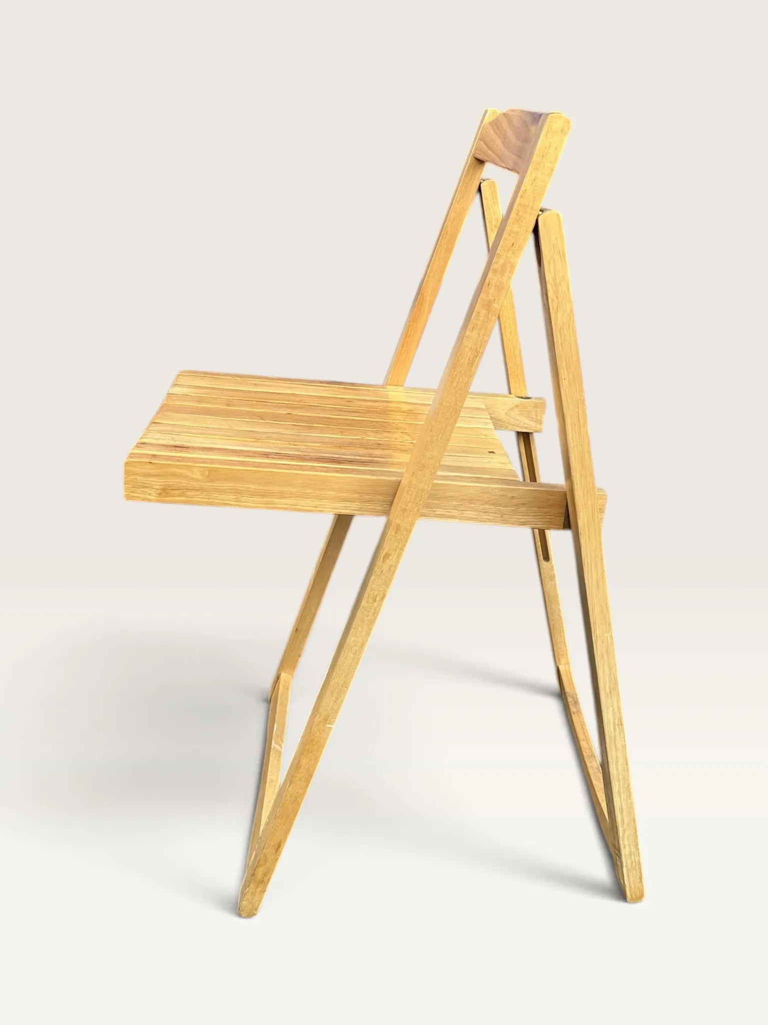 Blonde wooden folding chair in the style of Aldo Jacober.