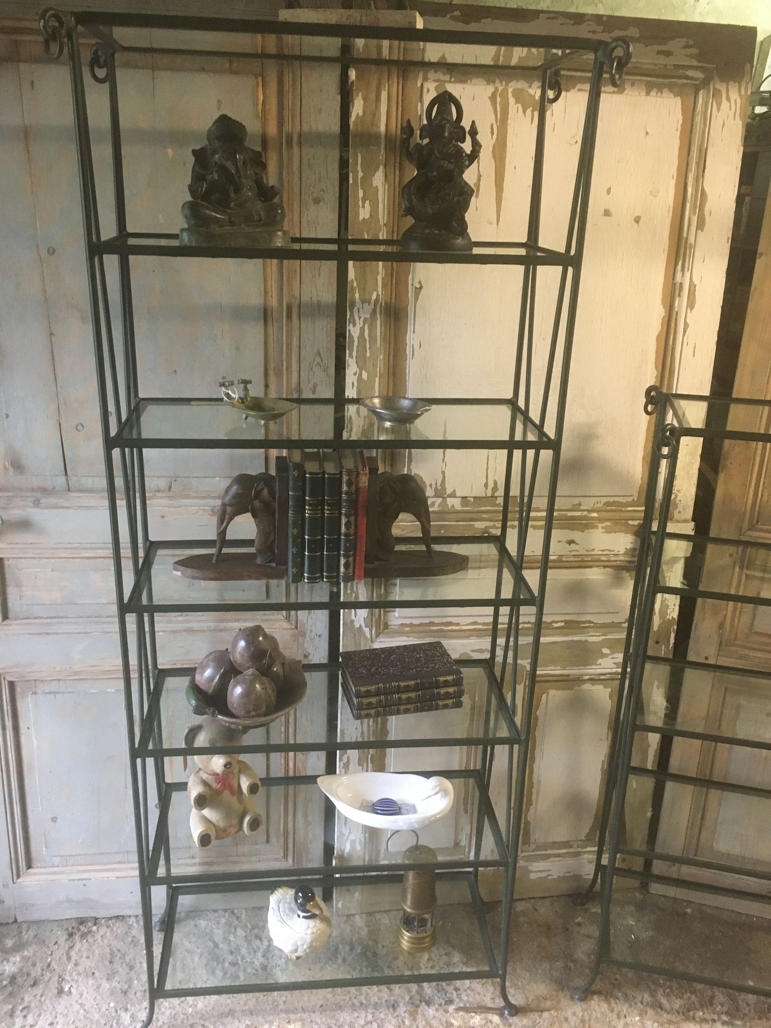 Pair of wrought iron and glass bookshelf shelves.