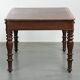 Antique English writing desk from the 19th century with a red leather top