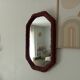 Vintage octagonal mirror in woven rattan.