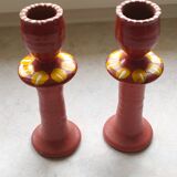 A pair of glazed earthenware candlesticks.