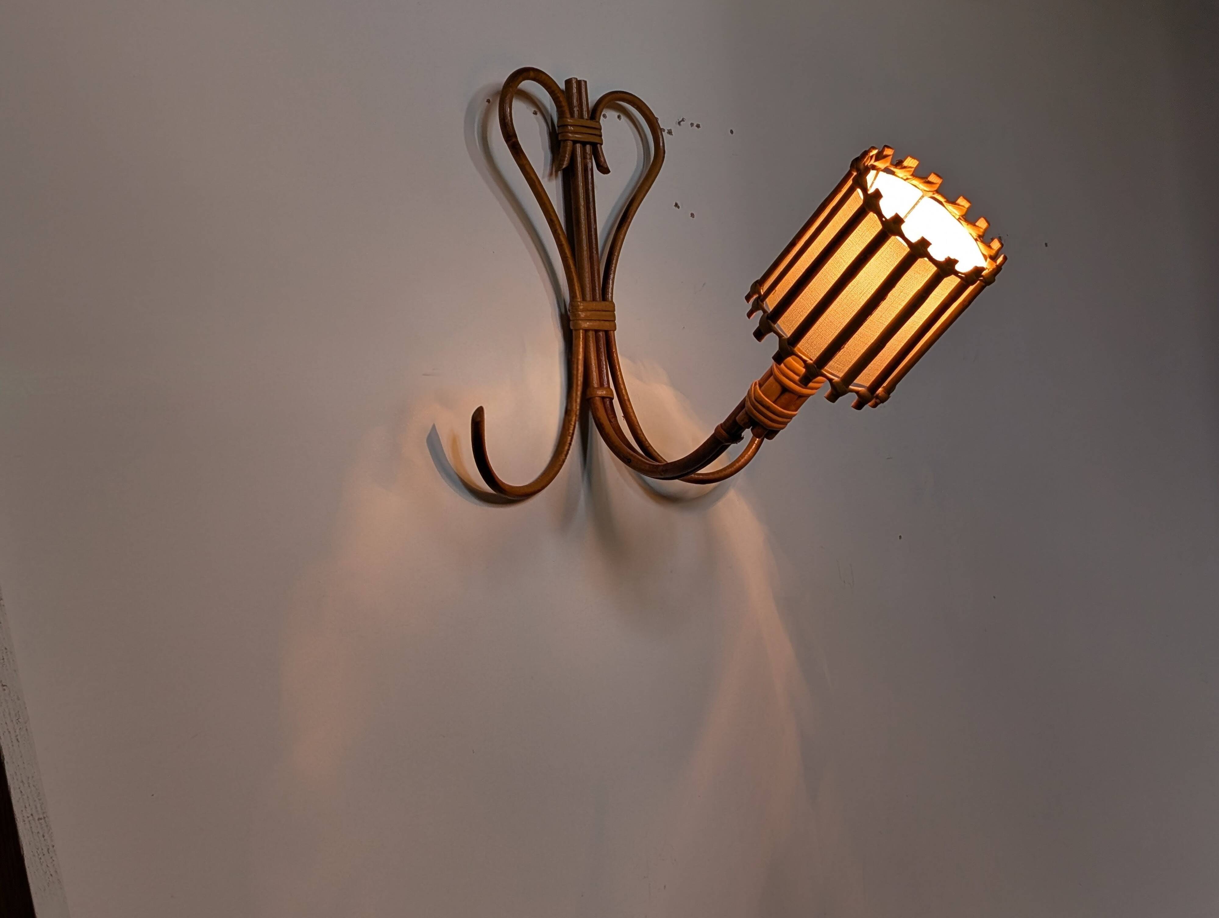 Rattan wall lights by Louis Sognot