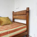 Brutalist style bed with chain and straw
