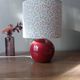 Red bedside lamp, liberty lampshade with small pink flowers.