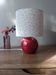 Red bedside lamp, liberty lampshade with small pink flowers.
