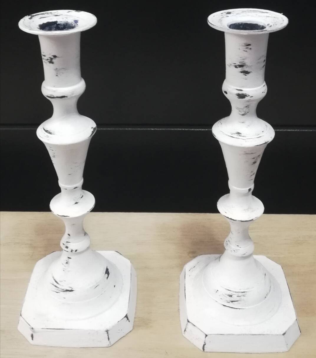 Pair of patinated white candlesticks