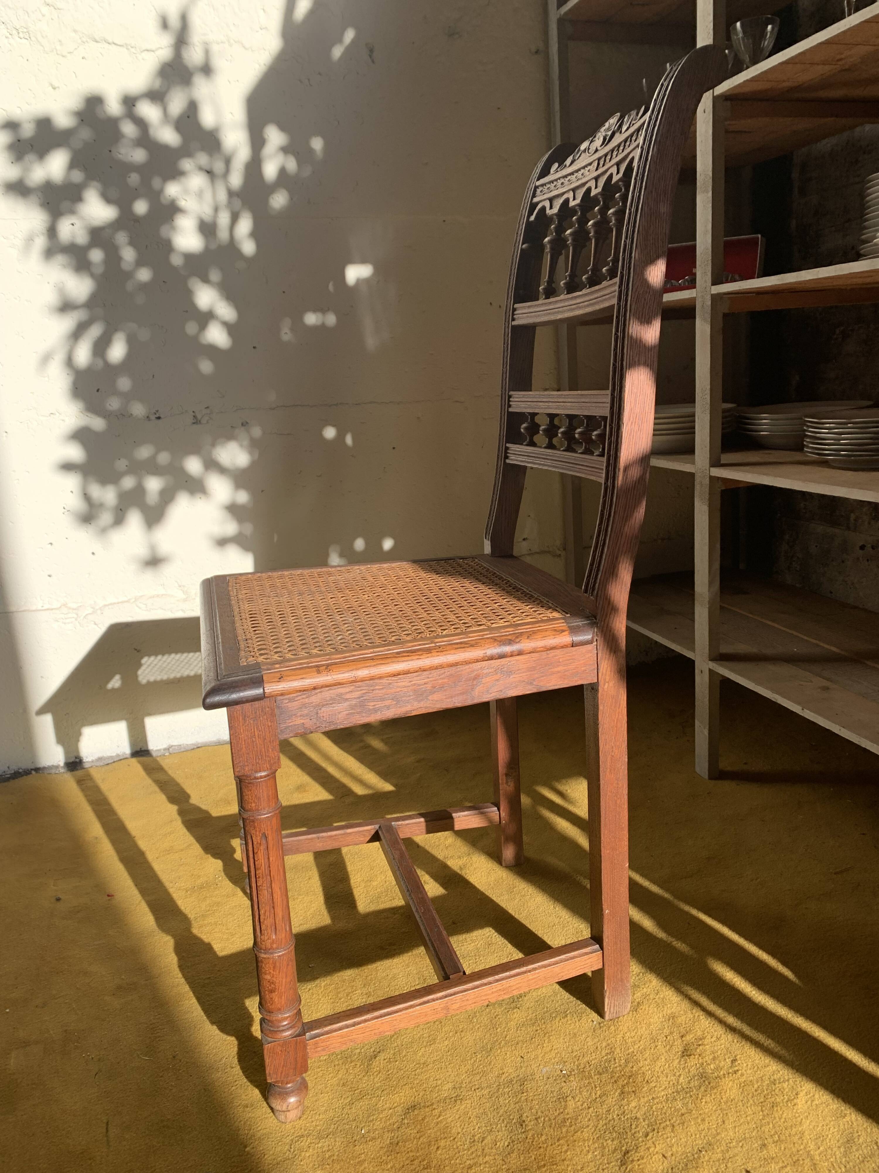 6 carved wooden chairs with cane seats