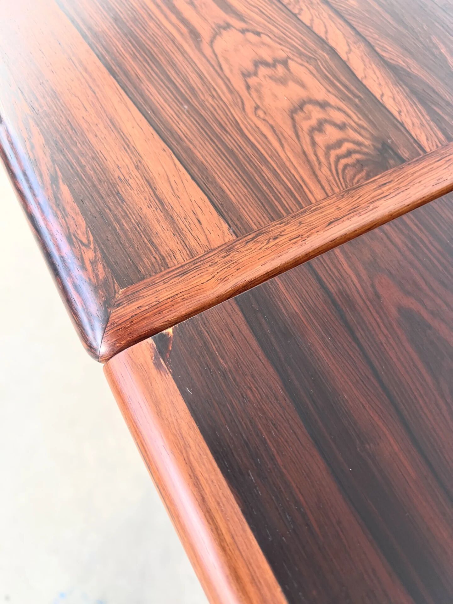 Rosewood dining table with integrated extensions — Denmark, 1960s