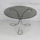 Table de séjour "Space Age" acier poli, dalle circulaire verre fumé. France, circa 1970.