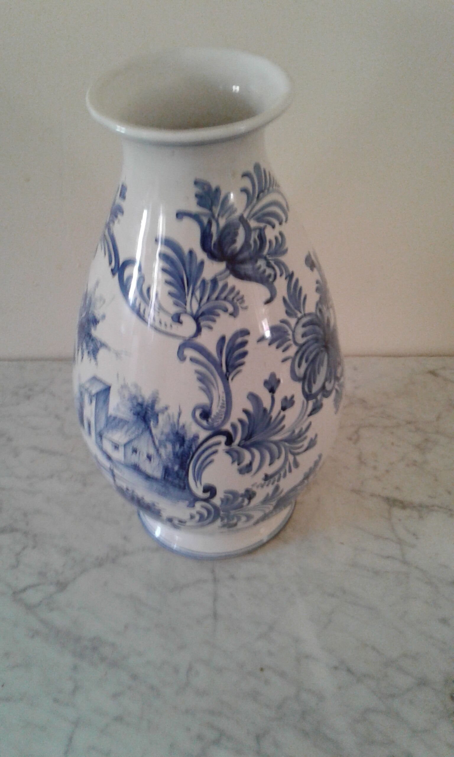 Blue vase adorned with blue and white