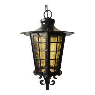 Large hanging lantern in wrought iron and opaque yellow-orange windows