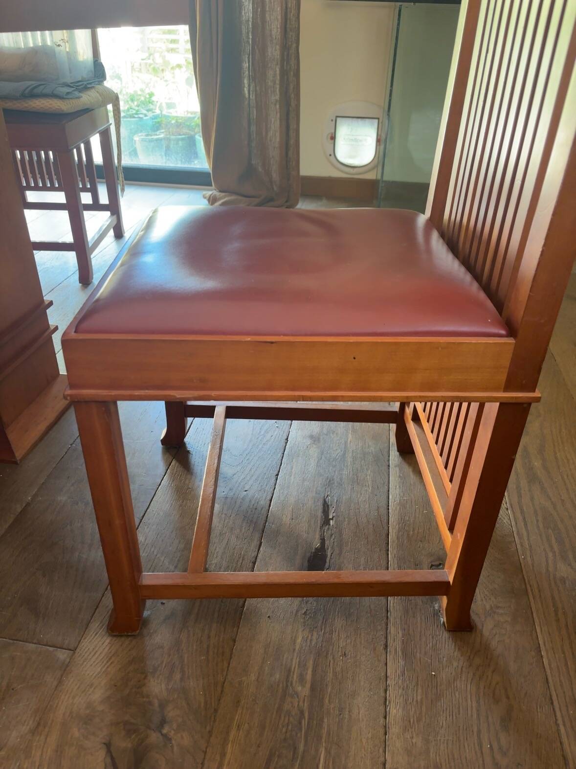 "Frank Lloyd Wright set with a table and its eight chairs."