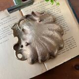 Bronze “shell” pocket emptier