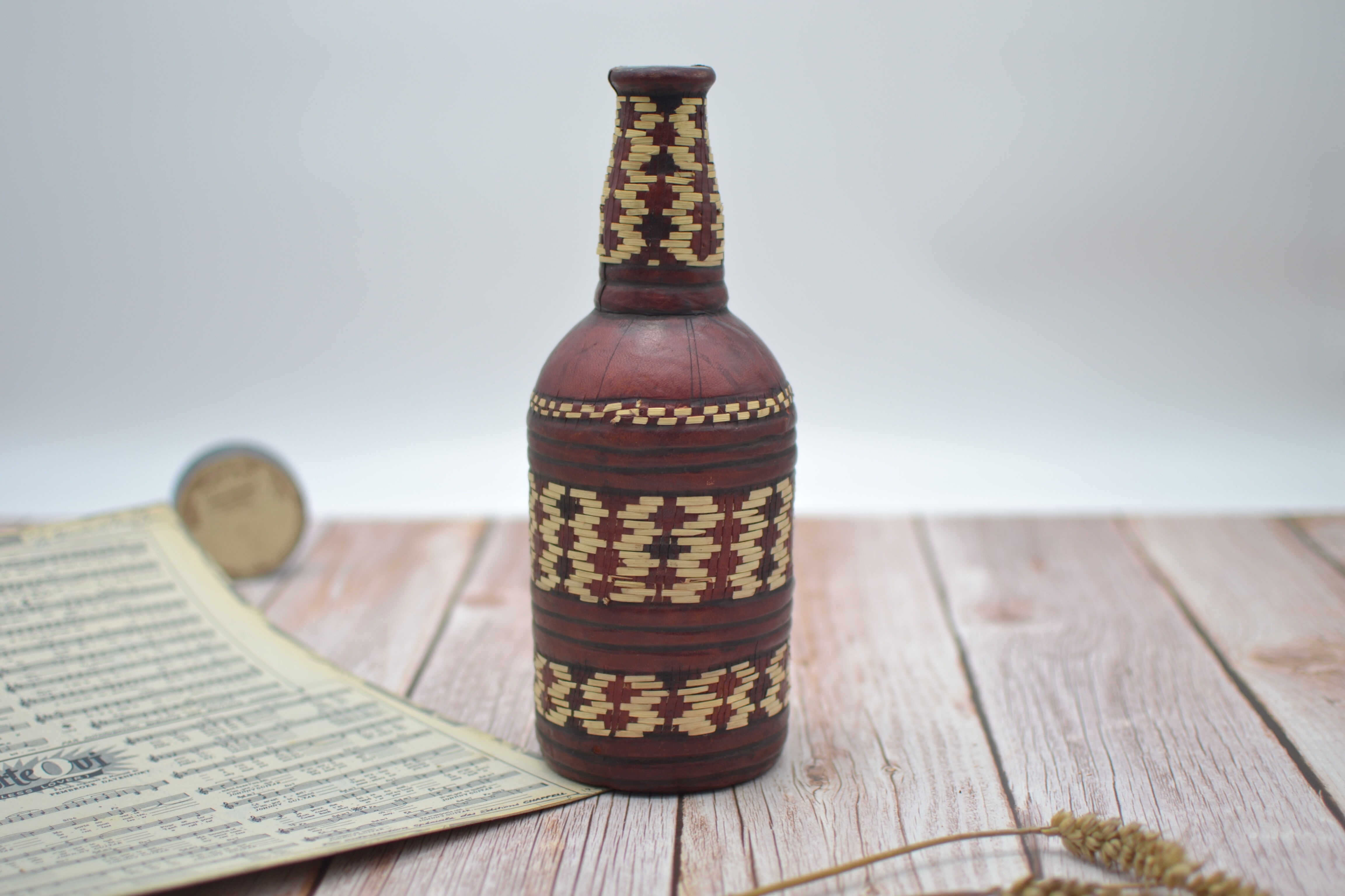 Set of 2 decorative vintage bottles covered with leather & wicker