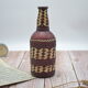 Set of 2 decorative vintage bottles covered with leather & wicker